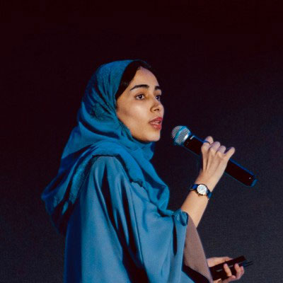 woman speakig with microphone Jawharah Alabdulqader